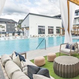 pool area showing reclining seating, wooden coverings and ample space